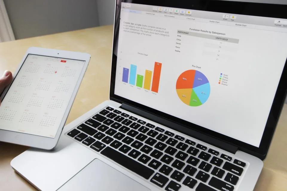 A laptop screen filled with dense rows of tabular data